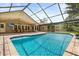 Gorgeous pool with a screened enclosure, patio area, and easy access to the home and landscaped yard at 548 Timber Ridge Dr, Longwood, FL 32779