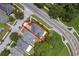 An aerial view of a home with a well-maintained yard and mature trees surrounded by lush greenery at 5852 Mariposa Cove Ln, Orlando, FL 32822