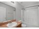 Bright bathroom features a shower-tub combo, light countertop, and modern fixtures at 5852 Mariposa Cove Ln, Orlando, FL 32822