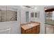 Bathroom with vanity and large mirror and adjacent to the shower at 5852 Mariposa Cove Ln, Orlando, FL 32822