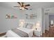 Stylishly staged bedroom with a ceiling fan, decorative shelves, and a comfortable bed at 5852 Mariposa Cove Ln, Orlando, FL 32822