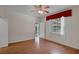 Guest bedroom with hard wood floors, access to outdoor patio area and window at 5852 Mariposa Cove Ln, Orlando, FL 32822