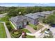 Aerial view of the property showcasing landscaping, a two-car garage, and mature trees at 5852 Mariposa Cove Ln, Orlando, FL 32822