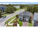 Aerial view of the property showcasing landscaping, a two-car garage, and mature trees at 5852 Mariposa Cove Ln, Orlando, FL 32822