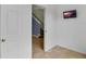 Hallway with neutral walls, tile flooring, and a view of carpeted stairs at 5852 Mariposa Cove Ln, Orlando, FL 32822