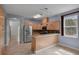 Bright kitchen features wood cabinetry, a breakfast bar, stainless appliances, and tile floors at 5852 Mariposa Cove Ln, Orlando, FL 32822