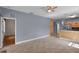 Open-concept living room boasts tile flooring, ceiling fan, and a seamless flow into the adjacent kitchen at 5852 Mariposa Cove Ln, Orlando, FL 32822