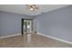 Neutral living room with tile floors, ceiling fan and access to outdoor patio area at 5852 Mariposa Cove Ln, Orlando, FL 32822