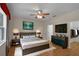 Spacious main bedroom boasts hard wood floors and features a large TV at 5852 Mariposa Cove Ln, Orlando, FL 32822