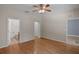 Large main bedroom with hard wood floors leads to bathroom and walk in closet at 5852 Mariposa Cove Ln, Orlando, FL 32822