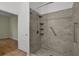 Shower features sleek tile design, integrated shelving, and stainless grab bars at 5852 Mariposa Cove Ln, Orlando, FL 32822