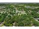 Aerial view displays property surrounded by lush greenery and nearby community parks and local amenities at 610 Kittredge Dr, Orlando, FL 32805