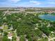 An aerial view highlights property's location near the city skyline, a lake, and lush neighborhoods at 610 Kittredge Dr, Orlando, FL 32805