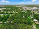 An aerial view showcases property amidst tree-lined streets and proximity to local shops and businesses at 610 Kittredge Dr, Orlando, FL 32805