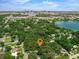 Aerial view highlights property's location near the city skyline, a lake, and tree-lined streets at 610 Kittredge Dr, Orlando, FL 32805