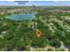 Aerial view of property near Camping World Stadium surrounded by lush greenery and a serene lake at 610 Kittredge Dr, Orlando, FL 32805