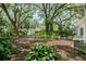 Sprawling backyard featuring mature trees, a storage shed, and a lush, green landscape at 610 Kittredge Dr, Orlando, FL 32805