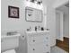A sleek bathroom featuring a stylish vanity, modern fixtures, and black and white patterned tile floors at 610 Kittredge Dr, Orlando, FL 32805