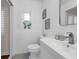 Bright white bathroom with decorative tile floor, tiled walls and modern fixtures at 610 Kittredge Dr, Orlando, FL 32805