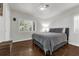 Comfortable bedroom with white walls, shutters, hardwood floors, and a cozy bed at 610 Kittredge Dr, Orlando, FL 32805