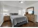 Neutral bedroom featuring a comfortable bed, wood dresser, and bright natural light at 610 Kittredge Dr, Orlando, FL 32805