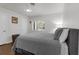White bedroom featuring shutters, hardwood floors, and comfortable bedding at 610 Kittredge Dr, Orlando, FL 32805