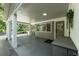 Covered carport with access to the home's entrance, featuring a functional design with stylish columns and ample space at 610 Kittredge Dr, Orlando, FL 32805