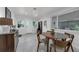 Cozy dining room with a round wooden table and access to the backyard and other living spaces at 610 Kittredge Dr, Orlando, FL 32805