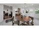Dining room area with round wooden table in open floor plan provides easy access to the back yard at 610 Kittredge Dr, Orlando, FL 32805