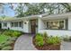 Inviting home exterior with a brick walkway, tidy landscaping, and a charming front entrance with stylish accents at 610 Kittredge Dr, Orlando, FL 32805