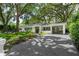 Beautiful home with a manicured lawn and stylish curb appeal, featuring a covered carport and inviting front entrance at 610 Kittredge Dr, Orlando, FL 32805