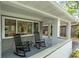 Relaxing covered front porch with rocking chairs, offering a cozy spot to enjoy the outdoors and neighborhood views at 610 Kittredge Dr, Orlando, FL 32805