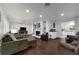 Bright living room with hardwood floors, fireplace, built-in shelves, and an open layout to the kitchen at 610 Kittredge Dr, Orlando, FL 32805