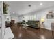 Bright living room with dark wood floors, fireplace, large windows, and comfortable furniture at 610 Kittredge Dr, Orlando, FL 32805