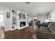 Spacious living room with a painted brick fireplace and built-in shelving, perfect for gatherings at 610 Kittredge Dr, Orlando, FL 32805