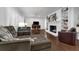Bright living room with plantation shutters, hardwood floors, and a cozy fireplace with built-in shelving at 610 Kittredge Dr, Orlando, FL 32805