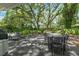 Outdoor patio with dining and lounge areas, surrounded by lush greenery and mature trees providing ample shade at 610 Kittredge Dr, Orlando, FL 32805