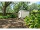 Backyard shed surrounded by lush greenery and trees for extra storage at 610 Kittredge Dr, Orlando, FL 32805