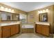 Spacious bathroom with double sinks, a large tub, and a window bringing in natural light at 7621 Brightwater Pl, Oviedo, FL 32765