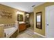 Well-appointed bathroom featuring a glass shower, soaking tub, and warm, neutral color palette at 7621 Brightwater Pl, Oviedo, FL 32765