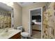 Bathroom with shower, toilet, mirror, and surf themed shower curtain at 7621 Brightwater Pl, Oviedo, FL 32765