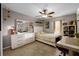 Comfortable bedroom featuring a bed, dresser, workspace, and natural light at 7621 Brightwater Pl, Oviedo, FL 32765