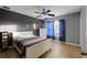 Bedroom features ceiling fan, and tiled floor with grey accent wall at 7621 Brightwater Pl, Oviedo, FL 32765
