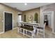 Cozy dining room with rustic brick accent wall, bench seating, and stylish mirror at 7621 Brightwater Pl, Oviedo, FL 32765