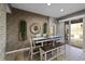 Dining area with decorative brick wall and sliding doors to the outdoor swimming pool at 7621 Brightwater Pl, Oviedo, FL 32765