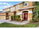 Charming two-story home with a well-maintained front yard and inviting red front door at 7621 Brightwater Pl, Oviedo, FL 32765