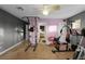 Home fitness room with exercise equipment, pink wall, and tile flooring at 7621 Brightwater Pl, Oviedo, FL 32765