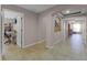 Hallway featuring neutral paint, arched doorways, and tile flooring leading to various rooms at 7621 Brightwater Pl, Oviedo, FL 32765