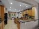 Well-appointed kitchen featuring granite countertops, stainless steel appliances, and a brick accent wall at 7621 Brightwater Pl, Oviedo, FL 32765