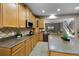 Bright kitchen features granite countertops, wood cabinets, tile flooring, and modern appliances at 7621 Brightwater Pl, Oviedo, FL 32765
